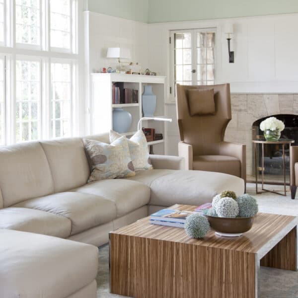 Bright living room with fireplace, prepared for guests after an occasional clean