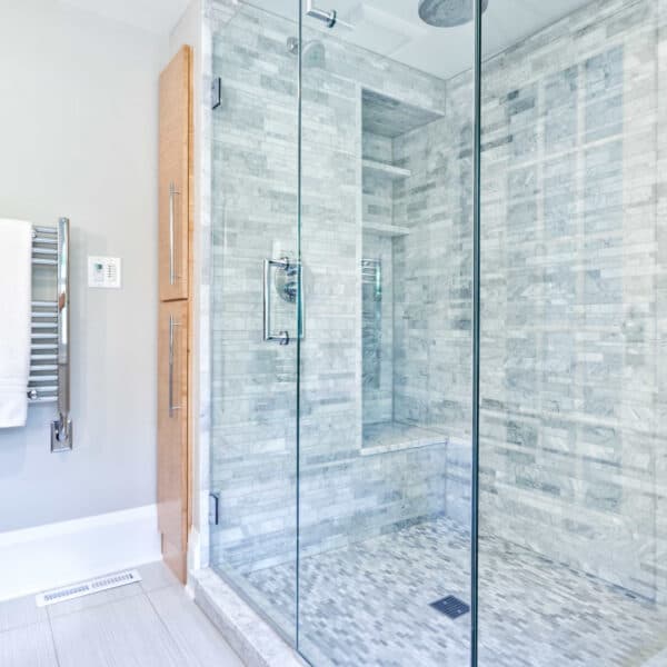 Marble shower scrubbed during a deep cleaning service